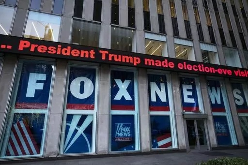 A headline about President Donald Trump is displayed outside Fox News studios in New York on Nov. 28, 2018. Dominion Voting Systems' defamation case against Fox News over its airing of false allegations about the 2020 presidential election will go to trial after a Delaware judge allowed a jury to decide whether the conservative network aired the claims with actual malice, the standard for proving libel. (AP Photo/Mark Lennihan, File)