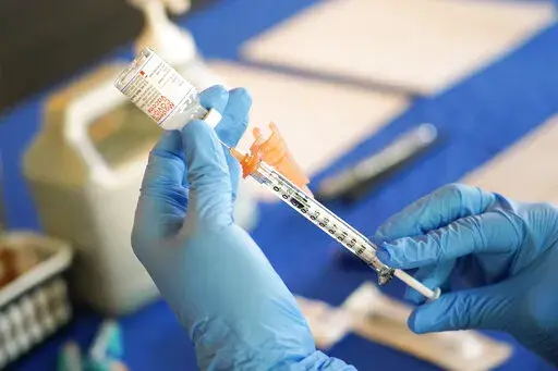 A nurse prepares a syringe of a COVID-19 vaccine at an inoculation station in Jackson, Miss., Tuesday, July 19, 2022. On Friday, Dec. 30, The Associated Press reported on stories circulating online incorrectly claiming the COVID-19 vaccines “are a gene therapy." (AP Photo/Rogelio V. Solis, File)