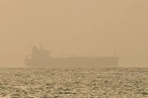 An oil tanker is moored off Fujairah, United Arab Emirates, Wednesday, Aug. 4, 2021. Technology to hide a ship's location previously available only to the world's militaries is spreading fast through the global maritime industry as governments from Iran to Venezuela — and the rogue shipping companies they depend on to move their petroleum products — look for stealthier ways to circumvent U.S. sanctions. (AP Photo/Jon Gambrell)