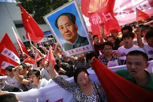 Anti-Japan protesters on disputed islands march near the Japanese Consulate General in Shanghai, China, on Sept. 16, 2012. Japan and China on Thursday, Sept. 29, 2022, mark the 50th anniversary of the 1972 normalization of their ties, but there isn't much of a celebratory mood. (AP Photo/Eugene Hoshiko, File)