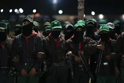 Members of the Zapatista National Liberation Army, EZLN, attend an event marking the 30th anniversary of the Zapatista uprising in Dolores Hidalgo, Chiapas, Mexico, Sunday, Dec. 31, 2023. (AP Photo/Eduardo Verdugo)
