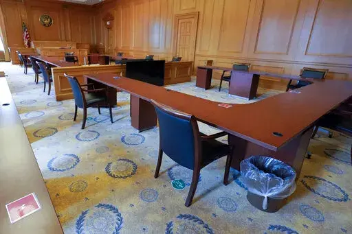 FILE — A courtroom is used as a jury deliberation room to allow for proper social distancing amid the coronavirus pandemic at a Manhattan federal courthouse, March 12, 2021, in New York. Judge Alison J. Nathan, the judge presiding over the sex trafficking trial of Ghislaine Maxwell, cited an "astronomical spike" in the number of coronavirus cases in New York City as she explained Tuesday, Dec. 28, 2021, why she was urging jurors to work longer hours. (AP Photo/Mary Altaffer, File)