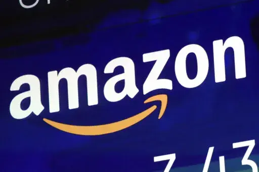 The logo for Amazon.com Inc. is displayed on a screen at the Nasdaq MarketSite, July 27, 2018.  House lawmakers have made good on their threat to seek a criminal investigation of Amazon, asking the Justice Department Wednesday to investigate whether Amazon and its senior executives obstructed Congress or violated other laws in testimony on the tech giant’s competition practices. The bipartisan battle against the world’s biggest online retailer by the House Judiciary Committee escalated with 
