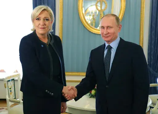 Russian President Vladimir Putin, right, shakes hands with French far-right presidential candidate Marine Le Pen, in the Kremlin in Moscow, Russia, Friday, March 24, 2017. France is thousands of miles from Ukraine, but what happens in French voting stations this month could have repercussions in Ukrainian battlefields. Nationalist candidate Marine Le Pen wants to halt arms supplies to Ukraine, improve Western ties with Russia and weaken the EU and NATO, which would undermine long-held Western al