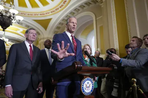Senate Majority Leader John Thune, R-S.D., joined by Sen. John Barrasso, R-Wyo., the GOP whip, left, talks to reporters at the Capitol, in Washington, Tuesday, April 1, 2025. (AP Photo/J. Scott Applewhite)