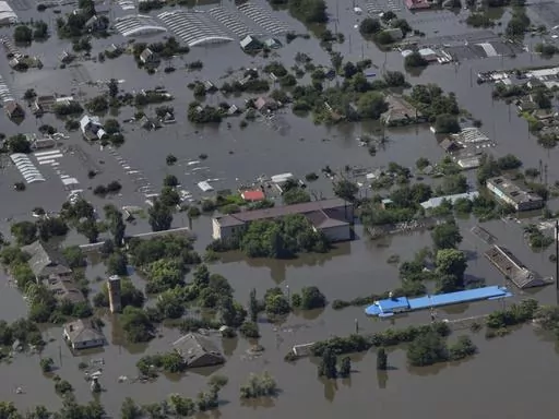 Houses are seen underwater in the flooded village of Dnipryany, in Russian-occupied Ukraine, Wednesday, June 7, 2023, after the collapse of Kakhovka Dam. Thousands of people are believed to be trapped by floodwaters spread across a swath of Ukraine after a catastrophic dam collapse. (AP Photo, File)