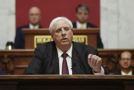 West Virginia Gov. Jim Justice delivers his annual State of the State address in the House Chambers of the state Capitol, Jan. 11, 2023, in Charleston, W.Va. Justice signed a bill Friday, March 22, 2024, that would ban smoking in cars with children present. West Virginia has the highest rate of adult cigarette use in the nation. (AP Photo/Chris Jackson, File)