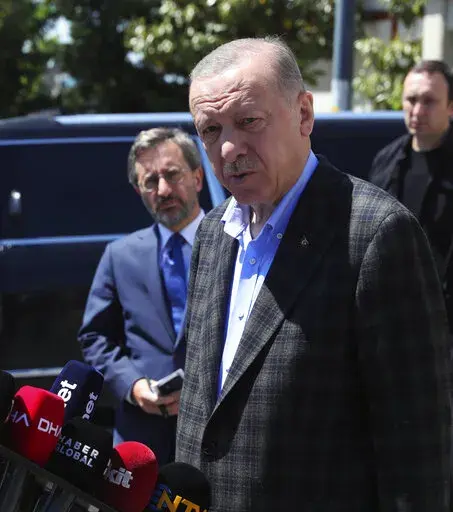In this photo made available by the Turkish Presidency, Turkish President Recep Tayyip Erdogan speaks to the media after Friday prayers, in Istanbul, Turkey, Friday, May 13, 2022. Erdogan said Friday that his country is "not favorable" toward Finland and Sweden joining NATO, indicating that Turkey could use its status as a member of the Western military alliance to veto moves to admit the two countries. (Turkish Presidency via AP)