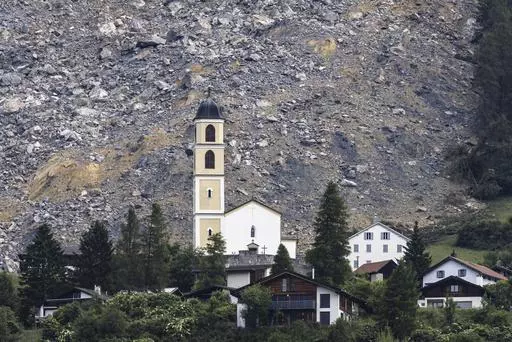 General view of part of the village of Brienz-Brinzauls below the rockfall "Brienzer Rutsch", in Switzerland, Friday, June 16, 2023. On Thursday night, a large part of the rock masses fell towards the village. The rock masses just missed the village and left behind a meter-high deposit on the main road near the school building. No one was injured since the village was evacuated on May 12. (Michael Buholzer/Keystone via AP)
