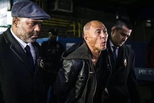 Weng Sor is walked by New York Police Department detectives out of the 68th Precinct in the Brooklyn borough of New York on Tuesday, Feb. 14, 2023. Sor was charged Tuesday with murder and attempted murder after he went on a deadly rampage with a U-Haul truck a day earlier in New York City. (AP Photo/Stefan Jeremiah)