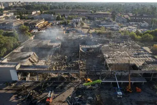 Ukrainian State Emergency Service firefighters work to take away debris at a shopping center burned after a rocket attack in Kremenchuk, Ukraine, Tuesday, June 28, 2022. While much of the attritional war in Ukraine’s east is hidden from sight, the brutality of Russian missile strikes in recent days on the mall in the central city of Kremenchuk and on residential buildings in the capital, Kyiv, were in full view to the world and especially to Western leaders gathered for a trio of summits in Eu