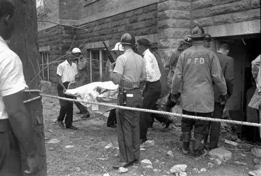 Firefighters and ambulance attendants remove a covered body from the 16th Street Baptist Church in Birmingham, Ala., Sept. 15, 1963, after a deadly explosion detonated by members of the Ku Klux Klan during services. Alabama on Friday, Sept. 15, 2023, will mark the 60th anniversary of the bombing that killed four girls. Lisa McNair, the sister of one of the victims, said as the anniversary is remembered, she hoped people will think about what they can do to combat hate. (AP Photo, File)