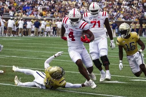 Mississippi running back Quinshon Judkins (4) gets past Georgia Tech defensive back Jaylon King (14) as he runs for a touchdown in the first half of an NCAA college football game, Saturday, Sept. 17, 2022, in Atlanta. (AP Photo/John Bazemore)