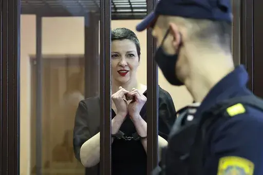 FILE – Belarus opposition activist Maria Kolesnikova stands behind bars in a defendants’ cage in a court in Minsk, Belarus, on Aug. 4, 2021. (Ramil Nasibulin/BelTA pool photo via AP, File)