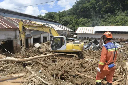 In this photo released by Xinhua News Agency, rescuers clear debris in a flood-affected area in Sishui Township of Pingyuan County, Meizhou City, southern China's Guangdong Province, June 20, 2024. Several people have died and others are missing after downpours caused historic flooding in rural parts of Guangdong province in southern China, while authorities warned Friday of more flooding ahead in other parts of the country. (Lu Hanxin/Xinhua via AP)