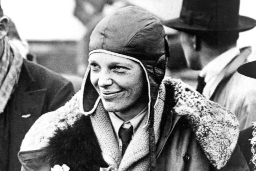 American aviatrix Amelia Earhart poses for photos as she arrives in Southampton, England, after her transatlantic flight on the "Friendship" from Burry Point, Wales, June 26, 1928. A leather helmet that Amelia Earhart wore on a flight across the Atlantic in 1928 and later lost in a crowd of fans in Cleveland, sold at auction for $825,000, Heritage Auctions said. (AP Photo/File)