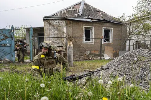 Ukrainian National Guard patrol during a reconnaissance mission in a recently retaken village on the outskirts of Kharkiv, east Ukraine, Saturday, May 14, 2022. (AP Photo/Bernat Armangue)