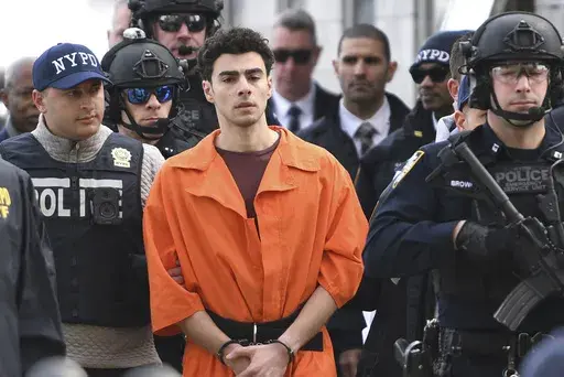 Luigi Mangione, a suspect in the fatal shooting of UnitedHealthcare CEO Brian Thompson, is escorted by police, Thursday, Dec. 19, 2024, in New York. (AP Photo/Pamela Smith)