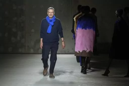 Belgian fashion designer Dries Van Noten accepts applause after his Fall/Winter 2024-2025 ready-to-wear collection presented Wednesday, Feb. 28, 2024 in Paris. Van Noten said Tuesday, March 19, 2024, he will step down from his namesake brand at the end of June. (Scott A Garfitt/Invision/AP, File)