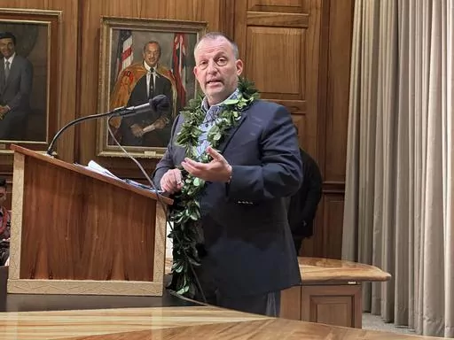 Hawaii Gov. Josh Green speaks at a news conference in Honolulu on Friday, Dec. 15, 2023. Green on Friday said he wants 3,000 condos and homes normally rented to Maui tourists on a short-term basis converted to long-term housing for displaced wildfire survivors who are now living in hotels and will use his emergency powers to achieve this if necessary.(AP Photo/Audrey McAvoy)