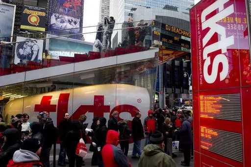 People wait in line at the Times Square TKTS discount ticket booth in New York on Jan. 19, 2012. The TKTS booth in Times Square, which has become part of the city's visual and financial DNA and a key part in keeping Broadway going, celebrates its 50th birthday this week. (AP Photo/Charles Sykes, File)