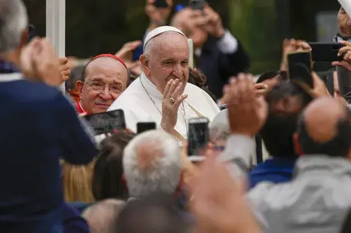 Pope Francis arrives to open the Holy Door of St. Mary in Collemaggio Basilica and start the jubilee of forgiveness, in L'Aquila, central Italy, Sunday, Aug. 28, 2022. Pope Francis will be the first pope since Celestine V to open this Holy Door, the first in history, established with the Bull of Forgiveness of 29 September 1294 by Pope Celestine V. (AP Photo/Domenico Stinellis)