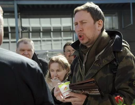 Paavo Arhinmaki, right, then leader of The Left Alliance and candidate for the Finnish Parliament, meets with voters during the party's election campaign in Helsinki, Finland, Saturday April 16, 2011. The current deputy mayor of Finland’s capital Arhinmaki is facing possible legal action, and calls for him to pay compensation for damages and to resign, after he was caught red-handed spray-painting graffiti in a railway tunnel on Friday, June 23, 2023. (Sari Gustafsson/Lehtikuva via AP, File)