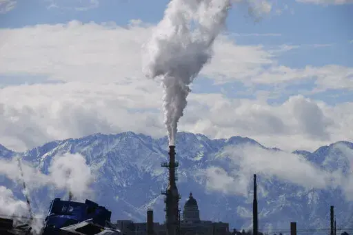 The Utah State Capitol, rear, is shown behind an oil refinery on May 12, 2022, in Salt Lake City. Once the world had hope that when nations got together they could stop climate change. Thirty years after leaders around the globe first got together to try, that hope has melted. (AP Photo/Rick Bowmer, File)