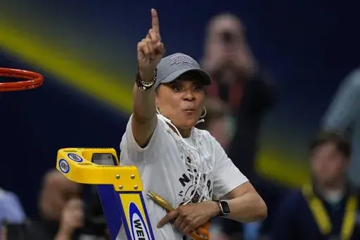 South Carolina head coach Dawn Staley cuts the net after a college basketball game in the final round of the Women's Final Four NCAA tournament against UConn, Sunday, April 3, 2022, in Minneapolis. Dawn Staley and South Carolina picked up right where they left off _ No. 1 in The Associated Press Top 25 women's basketball poll, Tuesday, Oct. 18. (AP Photo/Charlie Neibergall, File)