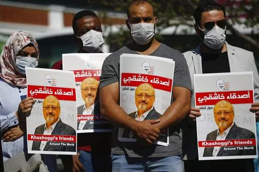People hold posters of slain Saudi journalist Jamal Khashoggi, near the Saudi Arabia consulate in Istanbul, marking the two-year anniversary of his death, Oct. 2, 2020. A Turkish court ruled Thursday, April 7, 2022 to suspend the trial in absentia of 26 Saudis accused in the gruesome killing of Washington Post columnist Jamal Khashoggi and for the case to be transferred to Saudi Arabia. (AP Photo/Emrah Gurel, File)