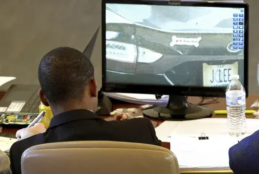 Sheldon Timothy Herrington Jr., who is charged in the 2022 death of University of Mississippi student Jimmie "Jay" Lee, looks at photos of Lee's car during Herrington's capital murder trial in Oxford, Miss., Thursday, Dec. 5, 2024. (Antonella Rescigno/The Daily Mississippian via AP, Pool)