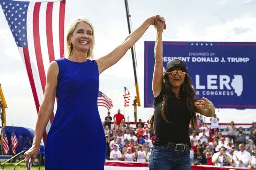 Rep. Mary Miller, R-Ill., left, is joined by Rep. Lauren Boebert, R-Colo., on stage at a rally at the Adams County Fairgrounds in Mendon, Ill., Saturday, June 25, 2022. (Mike Sorensen/Quincy Herald-Whig via AP)
