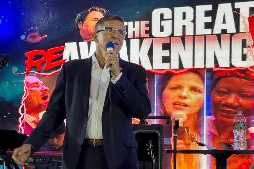 Michael Flynn, a retired three-star general who served as Trump's national security adviser, speaks on stage during the ReAwaken America tour at Cornerstone Church, in Batavia, N.Y., Friday, Aug. 12, 2022. Thousands of people gathered to hear his message that the nation is facing an existential threat, and to save it, his supporters must act. (AP Photo/Carolyn Kaster)