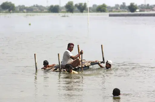 People use cot to salvage belongings from their nearby flooded home caused by heavy rain in Jaffarabad, a district of Pakistan's southwestern Baluchistan province, Saturday, Sep. 3, 2022. The homeless people affected by monsoon rains triggered devastating floods in Pakistan get enhancing international attention amid growing numbers of fatalities and homeless families across the country as the federal planning minister appealed the international community for immense humanitarian response for 33 