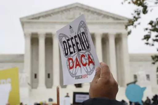 People rally outside the Supreme Court over President Trump's decision to end the Deferred Action for Childhood Arrivals program (DACA), at the Supreme Court in Washington, Nov. 12, 2019. A federal judge on Wednesday, Sept. 13, 2023, declared illegal a revised version of a federal policy that prevents the deportation of hundreds of thousands of immigrants brought to the U.S. as children. (AP Photo/Jacquelyn Martin, File)