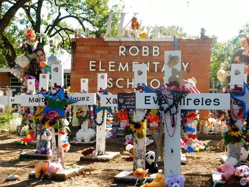 A memorial for the 19 children and two teachers killed in the May shooting sits outside of Robb Elementary on the first day of early voting, Monday, Oct. 24, 2022, in Uvalde, Texas.  The Uvalde school massacre has cast a long shadow in the midterm elections in Texas, intensifying Republican Gov. Greg Abbott’s reelection fight against Democrat Beto O’Rourke and driving a blitz of television ads. (AP Photo/Acacia Coronado)