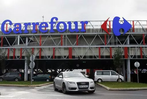 Car leaves a Carrefour supermarket in Anglet, southwestern France, on Jan.23, 2018. Global supermarket chain Carrefour will stop selling PepsiCo products in its stores in France, Belgium, Spain and Italy over price increases for popular items like Lay's potato chips, Quaker Oats, Lipton tea and its namesake soda. (AP Photo/Bob Edme, File)