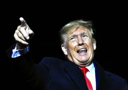 Former President Donald Trump speaks during a rally for Georgia GOP candidates at Banks County Dragway in Commerce, Ga., March 26, 2022. Trump last week filed a sprawling lawsuit accusing his 2016 rival Hillary Clinton and the Democratic Party. He accused them conspiring to sink his winning presidential campaign by alleging ties to Russia. It's the latest example of a long-standing tactic by Trump. The former president has spent decades repurposing political and personal grievances into causes o