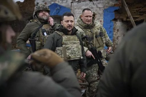 In this photo provided by the Ukrainian Presidential Press Office, Ukrainian President Volodymyr Zelenskyy, centre, during his visit to Zaporizhzhia region, the site of fierce battles with the Russian troops in Ukraine, Sunday, Feb. 4, 2024. (Ukrainian Presidential Press Office via AP)