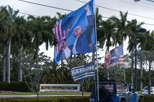 Flags brought by supporters wave in the breeze before President Donald Trump arrives at the Trump International Golf Club, Friday, April 4, 2025, in West Palm Beach, Fla. (AP Photo/Alex Brandon)
