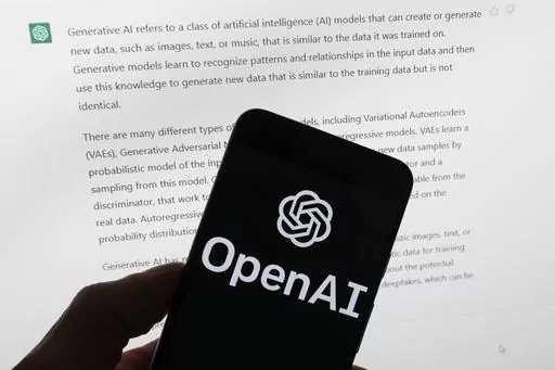 The OpenAI logo is seen on a mobile phone in front of a computer screen displaying output from ChatGPT, Tuesday, March 21, 2023, in Boston. Are tech companies moving too fast in rolling out powerful artificial intelligence technology that could one day outsmart humans? That is the conclusion of a group of prominent computer scientists and other tech industry notables who are calling for a 6-month pause to consider the risks. Their petition published Wednesday, March 29, 2023, is a response to Sa