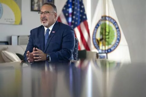 Education Secretary Miguel Cardona speaks during an interview with The Associated Press in his office at the Department of Education, Wednesday, Sept. 20, 2023 in Washington. (AP Photo/Mark Schiefelbein)