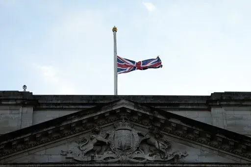 The Union flag on Buckingham Palace in London is lowered after the death of Britain's Queen Elizabeth II, Thursday, Sept. 8, 2022. Queen Elizabeth II, Britain's longest-reigning monarch and a rock of stability across much of a turbulent century, died Thursday after 70 years on the throne. She was 96. (AP Photo/Frank Augstein)