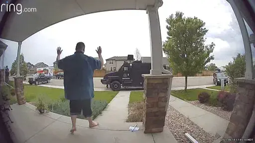 In this image from video provided by Leslie Bowman, Anderson Lee Aldrich surrenders to police at a home where his mother, Laura Voepel, was renting a room in Colorado Springs, Colo., on June 18, 2021. According to sealed law enforcement documents verified by The Associated Press, Aldrich's actions brought SWAT teams and the bomb squad to the normally quiet neighborhood, forced the grandparents to flee for their lives and prompted the evacuation of 10 nearby homes to escape a possible bomb blast.