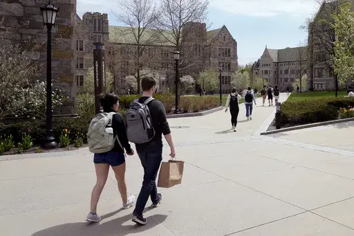 Students walk on the campus of Boston College, Monday, April 29, 2024, in Boston. Americans are increasingly skeptical about the value and cost of college, with most saying they feel the U.S. higher education system is headed in the “wrong direction,” according to a new poll. (AP Photo/Charles Krupa, File)