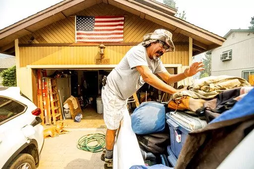 Michael Posadas packs his truck while preparing to evacuate from South Lake Tahoe, Calif., as the Caldor Fire approaches on Monday, Aug. 30, 2021. (AP Photo/Noah Berger)