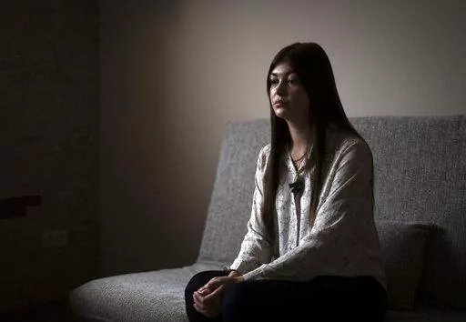 Alina Kapatsyna sits in a house in Dnipro, Ukraine, Friday, Jan. 6, 2023. Men in military uniforms took her mother 45-year-old Vita Hannych away from her house in eastern Ukraine in April. Since the war in Ukraine began, many civilians have been detained by Russian forces and are languishing in jails for months without charges as their relatives seek to find out what's happened to them. (AP Photo/Hanna Arhirova)