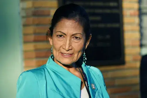 Secretary of the Interior Deb Haaland speaks with reporters while standing outside the Medgar and Myrlie Evers Home National Monument in Jackson, Miss., on Feb. 15, 2022. The Interior Department is on the verge of releasing a report on its investigation into the federal government's past oversight of Native American boarding schools. Interior Secretary Deb Haaland said Wednesday, March 16, 2022, the report will come out next month. (AP Photo/Rogelio V. Solis, File)