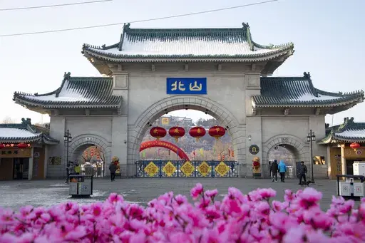 Tourists walk past a gateway with the name "Beishan" seen at the Beishan Park in northeastern China's Jilin province on Jan 23, 2020. Four instructors from Iowa's Cornell College teaching at Beihua University in northeastern China were attacked in the Beishan public park, reportedly with a knife, officials at the U.S. school and the State Department said Tuesday, June 11, 2024. (Zhu Wanchang/CNS Photos via AP)