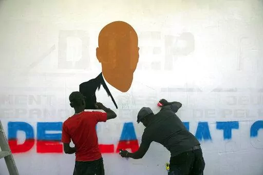 Artists paint a portrait of slain Haitian President Jovenel Moise near the presidencial residence where he was assassinated in the Petion-ville area of Port-au-Prince, Haiti, Thursday, July 7, 2022. A year has passed since Moise was assassinated at his private home. (AP Photo/Odelyn Joseph)